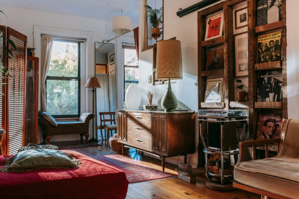 Warm and inviting vintage-style living room with record player, vintage furniture, and sunlight streaming through the window.